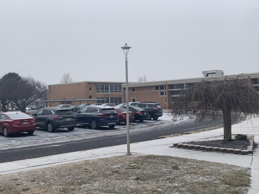 Snow falls lightly on Edison High as the area prepares for a potential winter storm.