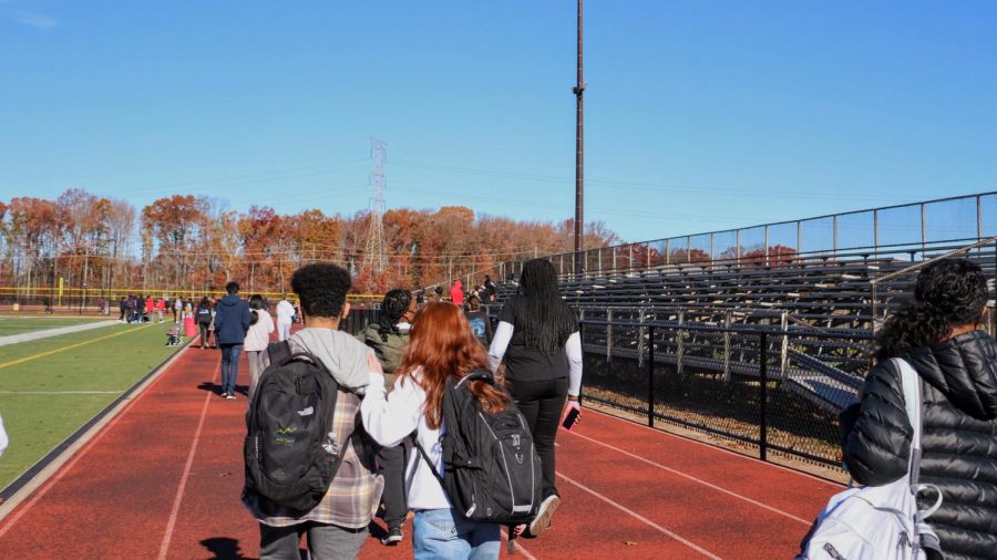 Students walk the track to raise awareness about health issues that men suffer from.