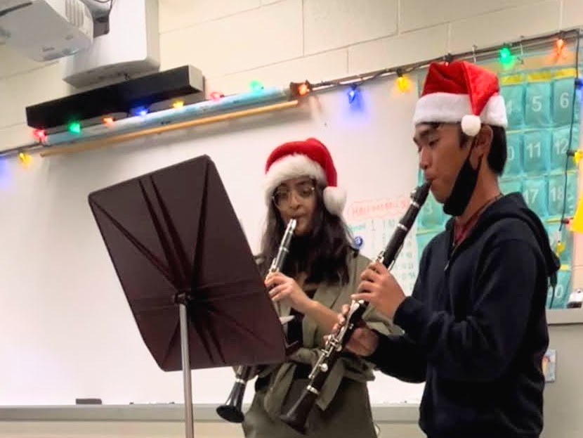 Aleena Cheriyan 22 and Elijah Agabao 22 playing  a Christmas Melody on the clarinet.