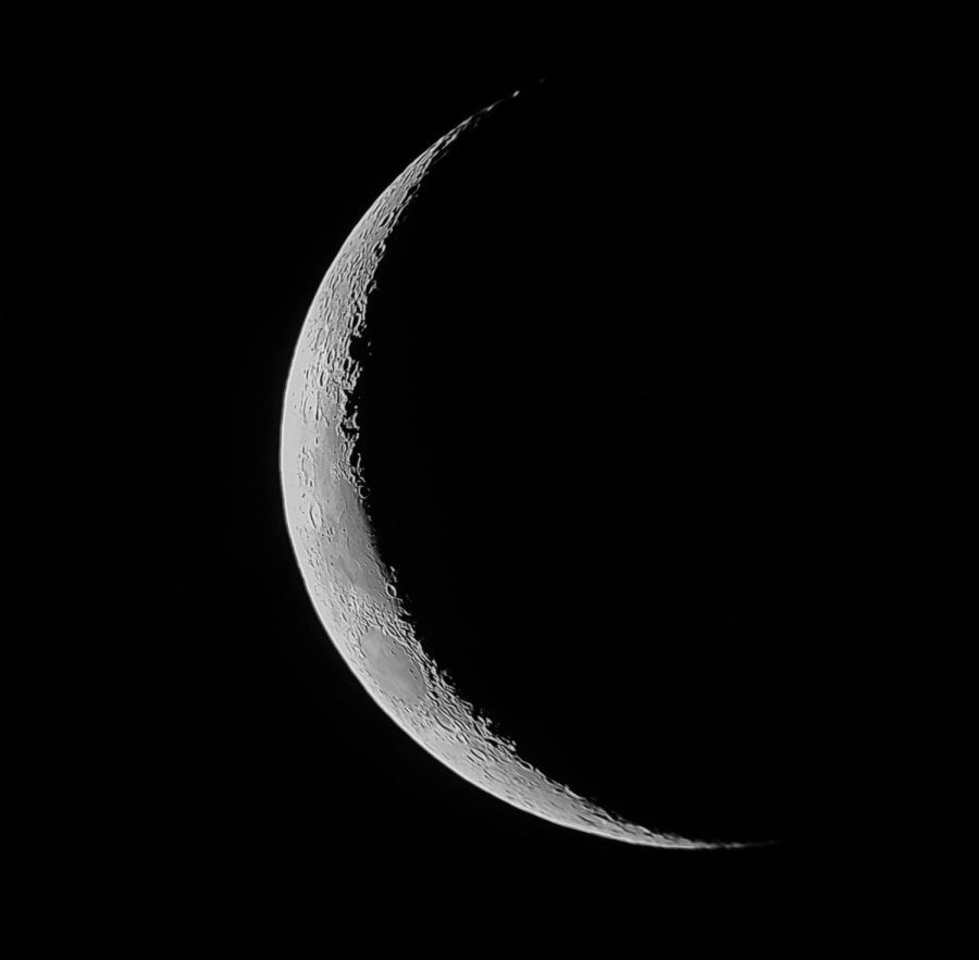 Photograph of a 3rd day moon. The terminator line (the line between night and dark) casts shadows upon craters and lunar maria, making them prominent.