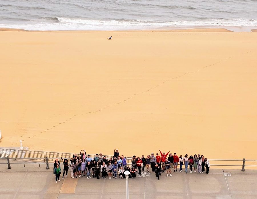 The Edison High School choir gathers in front of the scenic Virginia Beach to take a group photo. 