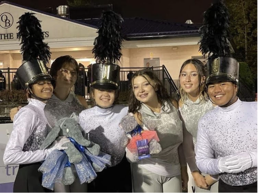(from left) Keya Raval 22, Alexis Kustka 22, Olivia Morales 22, Katelyn Robinson 22, Julia Webb 22, and Ross Turla 22 at a marching band competition.