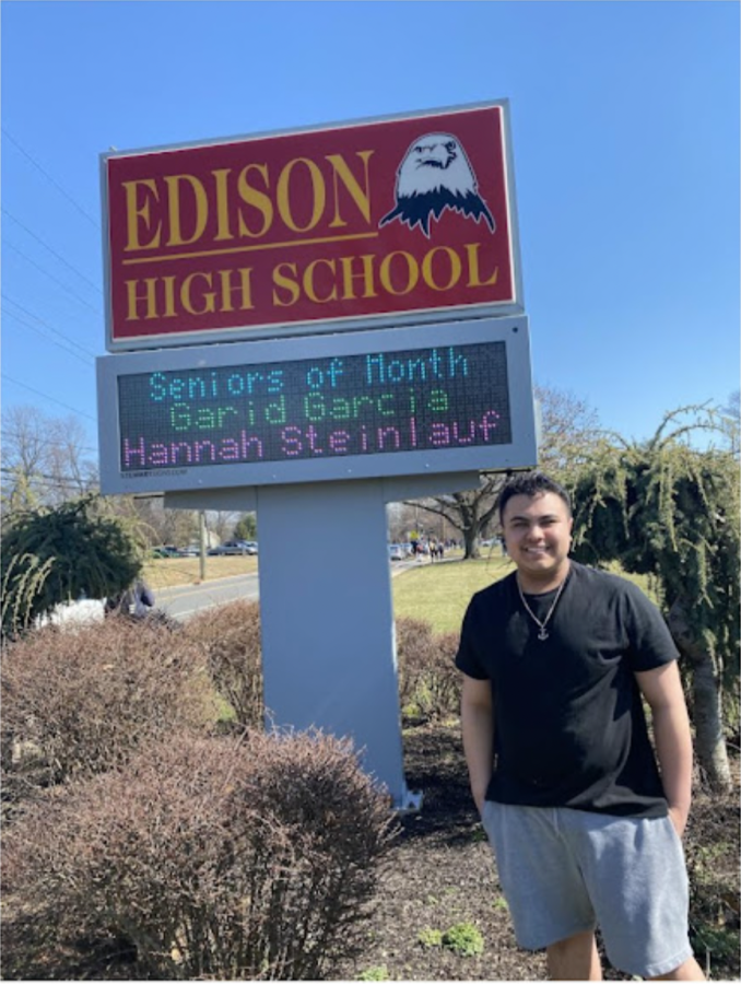 Garid Garcia 22 standing in front of his Senior of the Month sign. 