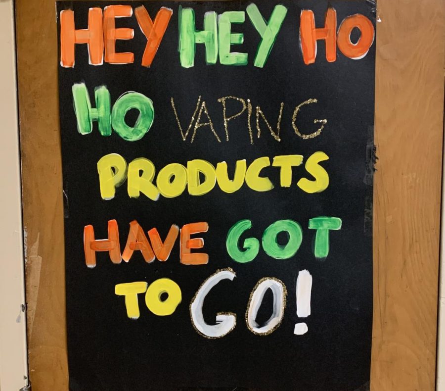 An anti-vaping sign hangs outside a restroom.