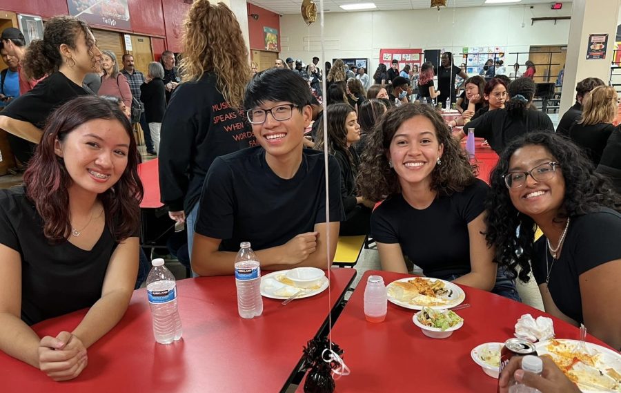 Robyn Nemeth 23, Christian Lee 23, Gabriela Engholm 23, and Remee Roy 23 took a food break during the Choirs Spaghetti Dinner and Concert.