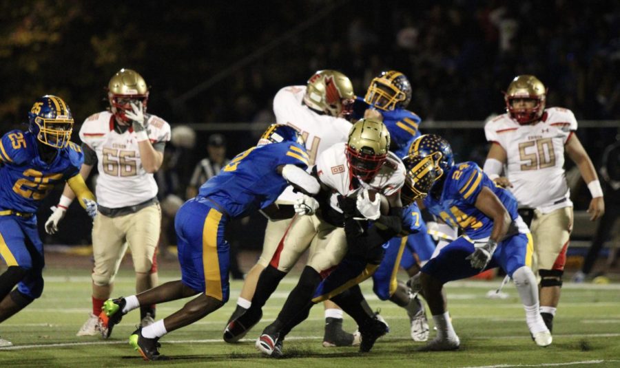 North Brunswick attempts to secure the ball from Edison player Nyekir Eato 25.