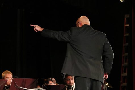 Head band director Marc Denicuolo directs Edisons Wind Ensemble