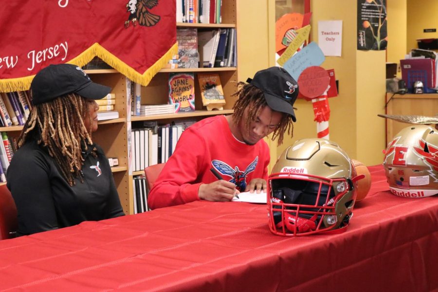 Malcolm Stansbury 23 signs his commitment to Delaware State Football alongside his mother.