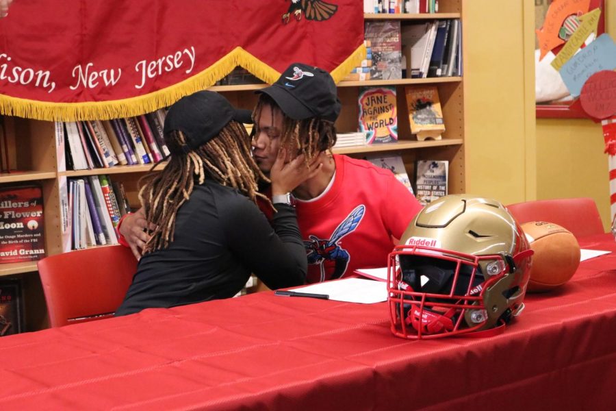 Malcolm Stansbury 23 embraces his mother after signing his National Letter of Intent for Delaware State University in the Media Center on February 1.