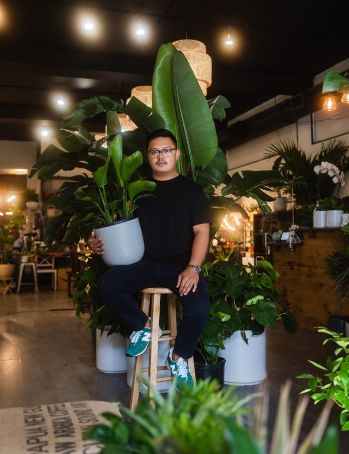 Peter Dario 15 poses with a plant at Terrace Plant Shop