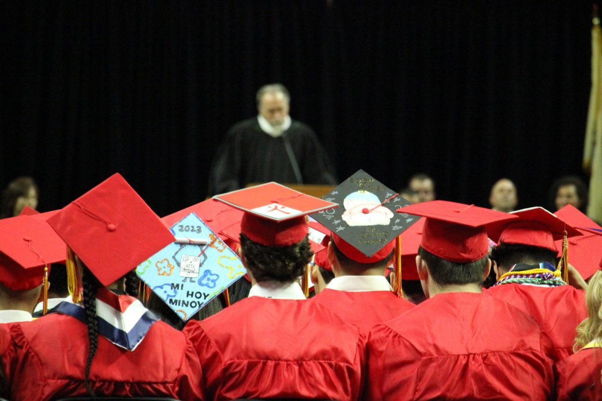 Graduates watch as principal Mr. Charles Ross gives the opening speech.