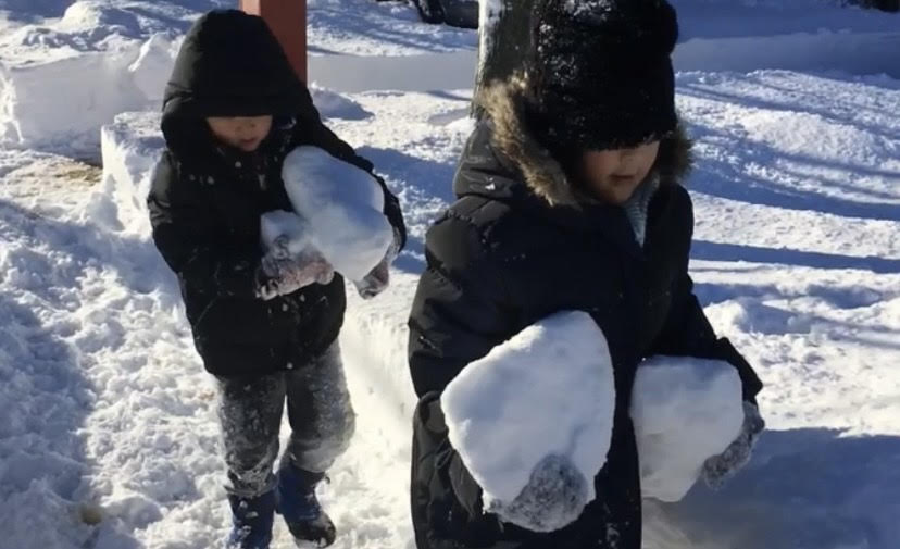 Dean Lee 26 (left) and Vivien Lee 25 (right) as kids holding blocks of snow
