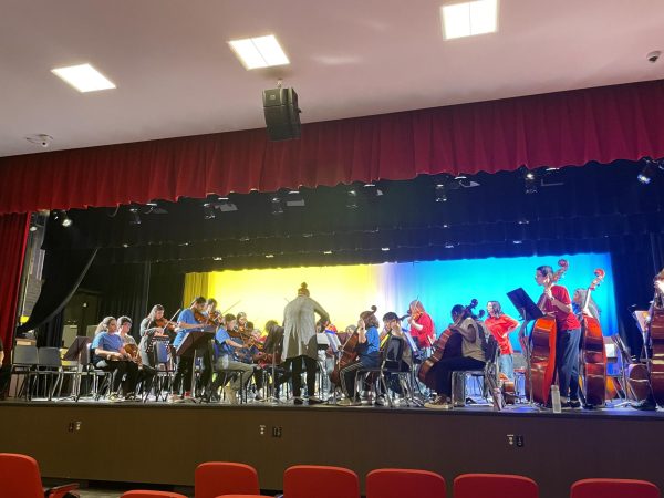Mrs. Elizabeth Maliszewski, the Herbert Hoover Middle School Orchestra director, conducts the combined Orchestra of Edison High and Herbert Hoover.