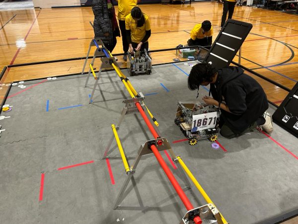 Mithil Mishra 25 works on the robots drone configuration on the practice field.