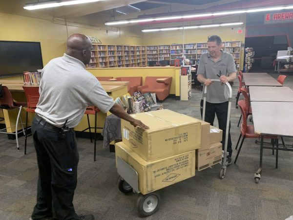 Mr. Carl Adams (left) and Mr. Tom Meagher, members of the EHS Maintenance Staff, deliver much-needed supplies to the E^3 Arena. This is one of the many aspects of their work, which also includes cleaning, sanitation, repair, and maintenance throughout the entire building.