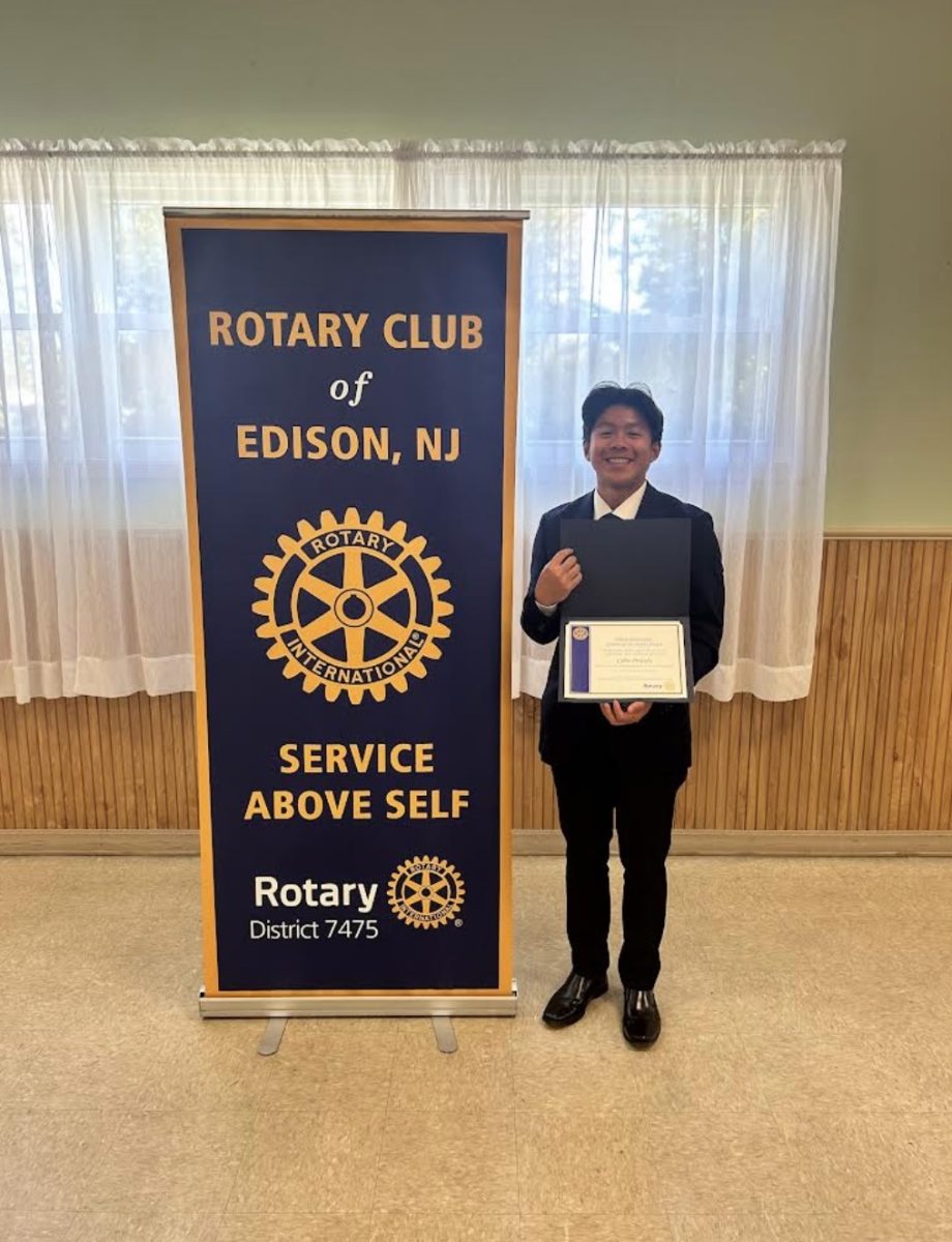 Colin Pridady '25 smiles with his certificate in hand as September's Rotary Senior of the Month.