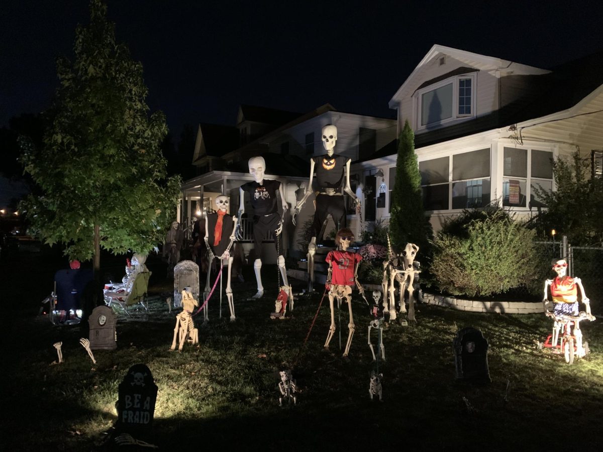 A series of skeleton props stand in Mr. McCaffery's front yard, dressed in various pieces of clothing and poses. How do you celebrate your halloween?