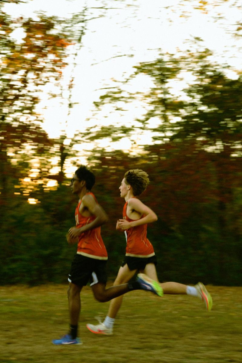 Sophomores Tanush Lingala '27 (left) and Niko Schneider '27 pace each other towards the final stretch of the varsity boys 5k race.