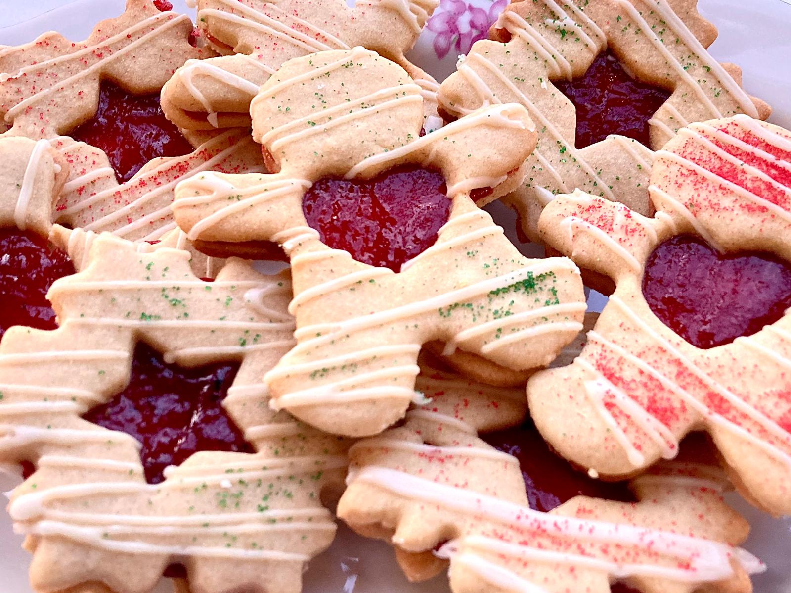 The Linzer cookies, assembled with the jam and decorated with icing and sprinkles.