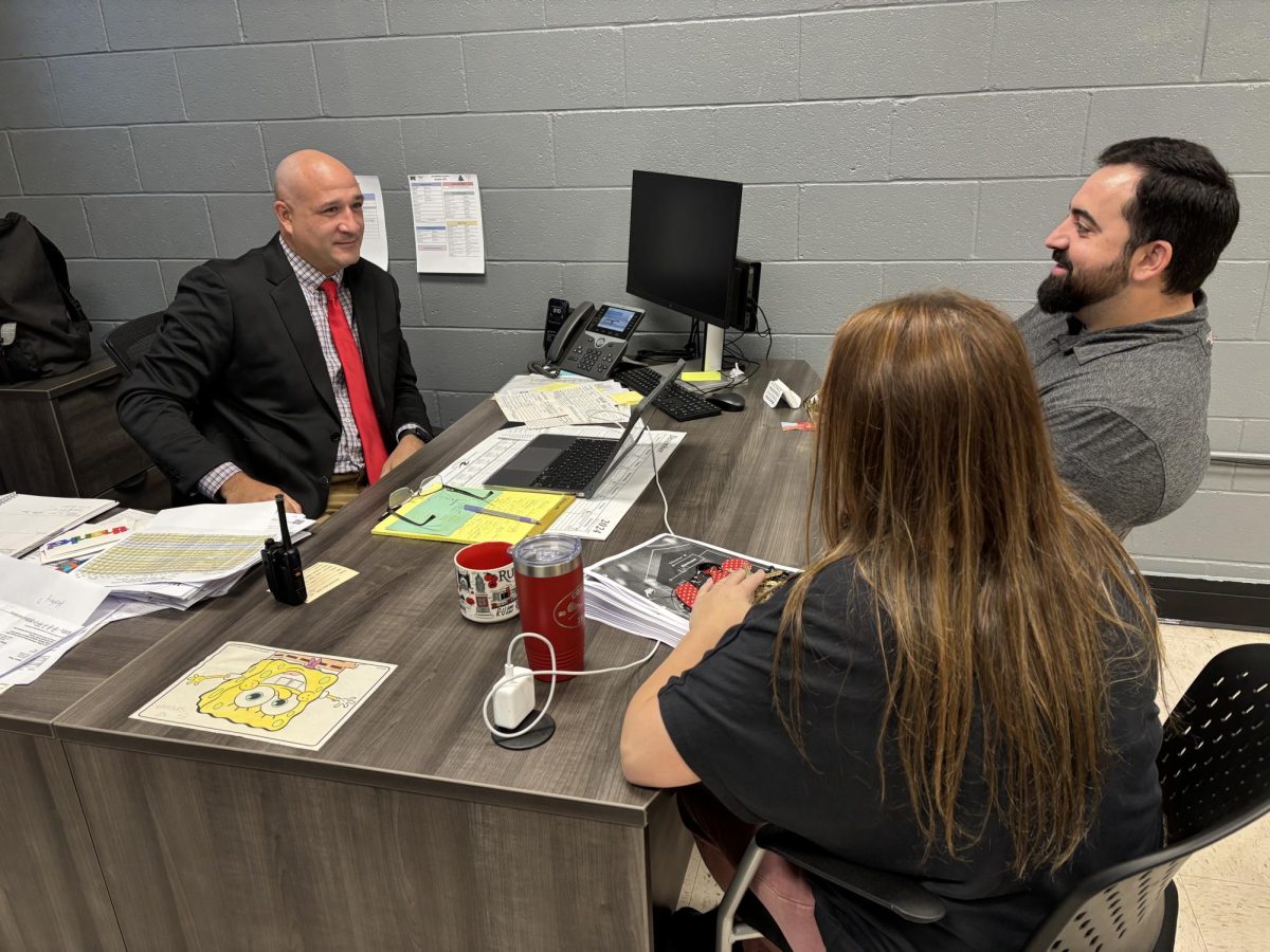 Vice principal Mr. Matt Zapoticzny conferences with staff in his new upstairs office. As the school's newest administrator, he has made his home in the history wing near the Breezeway stairs.