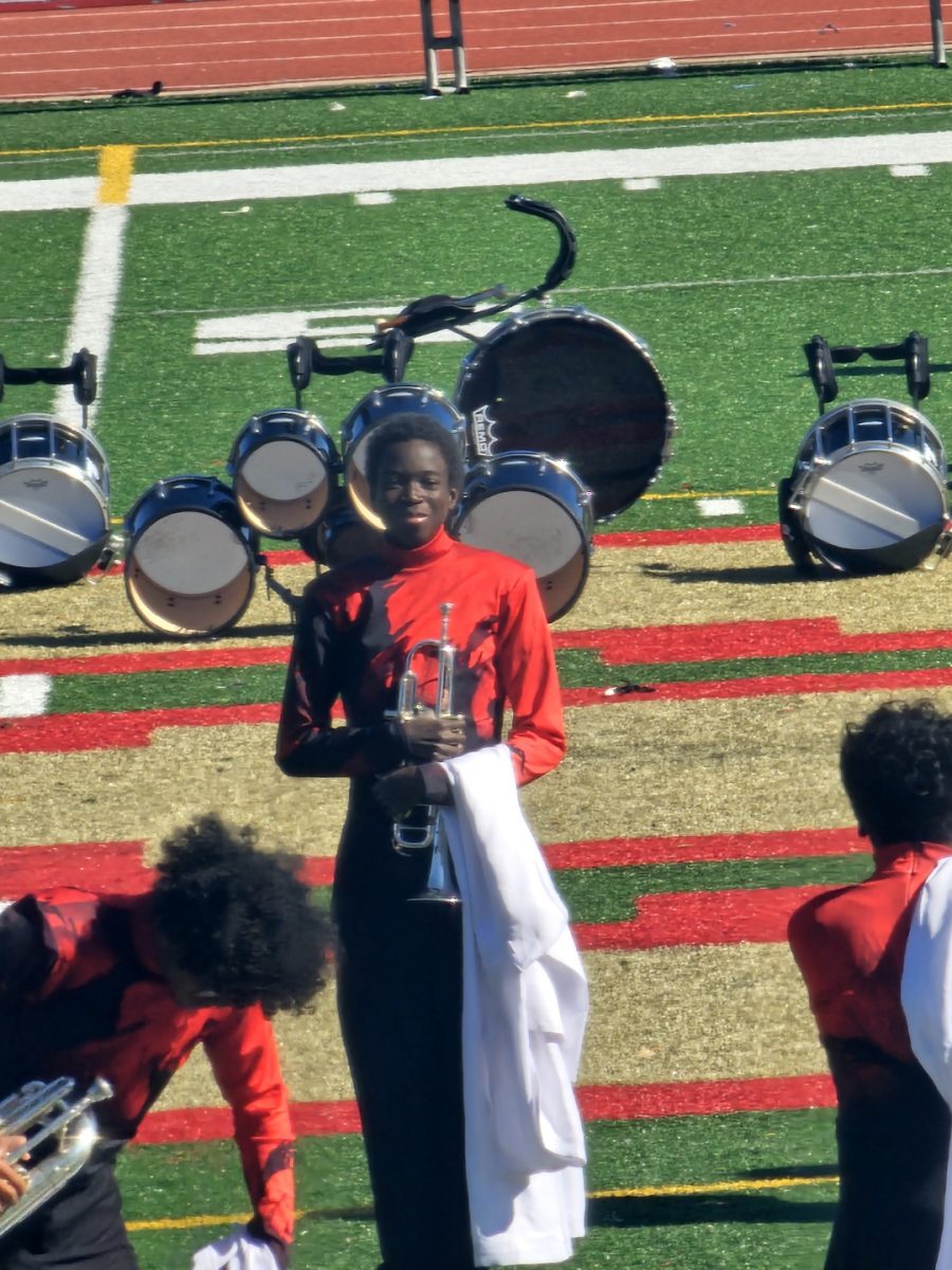 Edwin Taba '25, December's Senior of the Month, poses at a marching band performance.