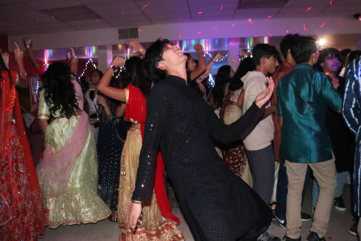 Arman Chotani '25 dances in the middle of his personal dance circle to the Bollywood music played by the DJ.