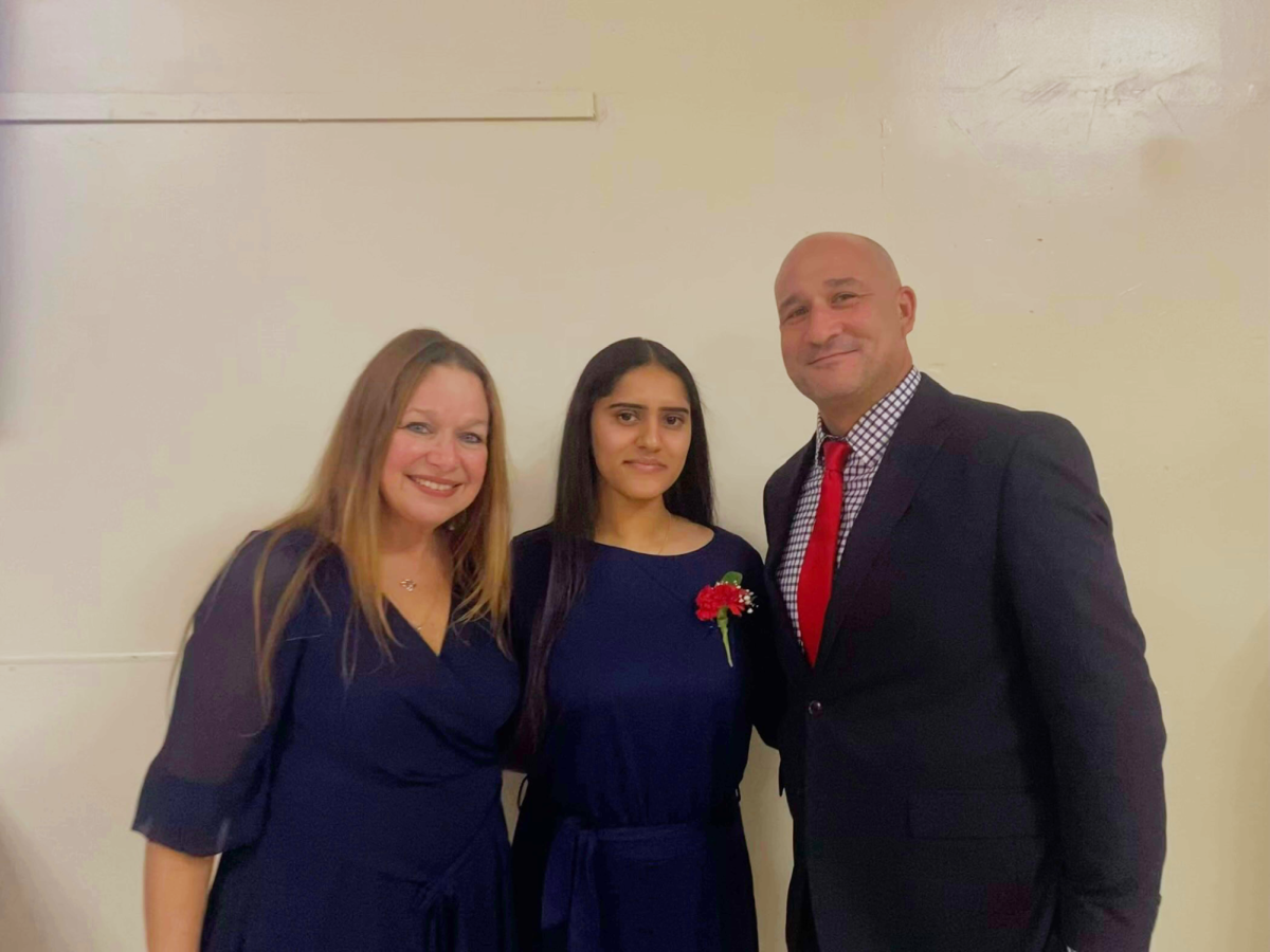 Jiya Thomas '25, Rotary's December Senior of the Month, stands with her AP French teacher Mrs. Deana Loria (left), and Vice Principal Mr. Matthew Zapoticzny at the World Language Honors Inductions.