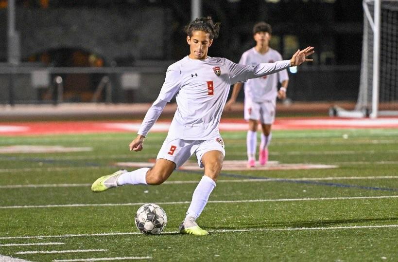 The EHS boys varsity soccer team's very own Emmanuel Kostis '26, takes a great shot towards the goal during an away game.