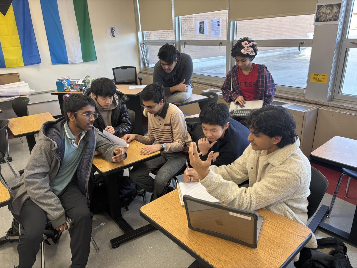 The Ethics Bowl team gathers in Room 234 to plan and practice for their next event. Led by team captian Aarya Mirajkar ‘26 (at right, rear), the team meets weekly to go over material, do research, and prepare arguments for competitions. 