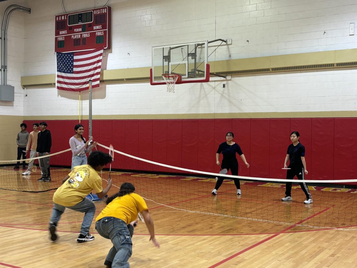 One of several matches pictured within the small gym, as players and student-referees join together for this chairity event.