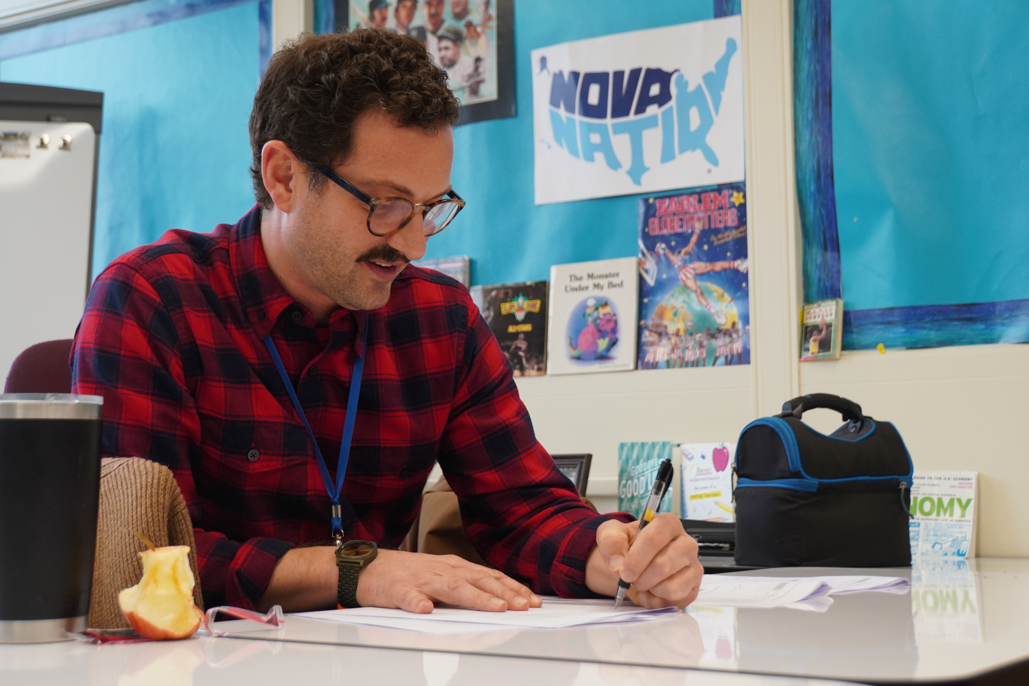 Mr. Wayne Younghans, a Math Interventionist, works on papers at his desk. He hopes that students are open to try new things and are involved in the activities here at EHS.