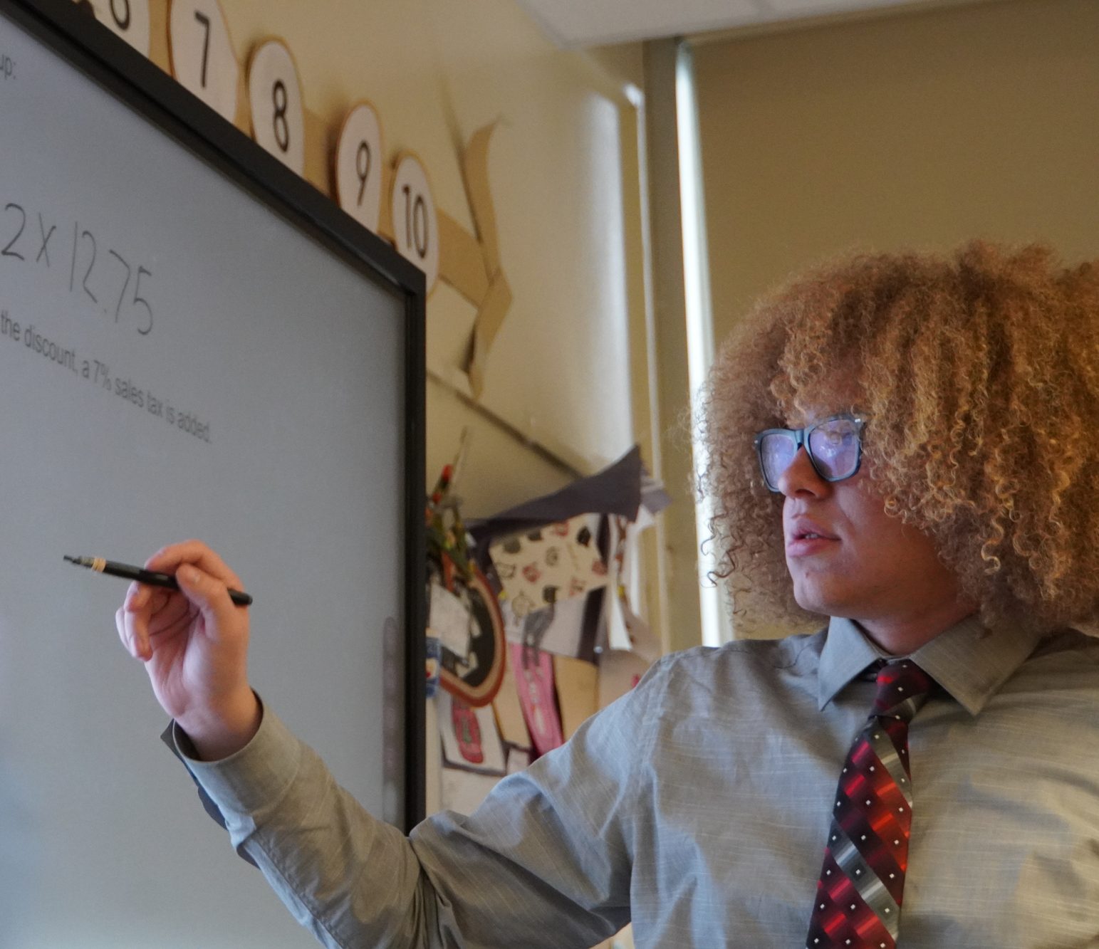 Mathematics teacher and EHS alum Mr. Alexander Yakowenko '23 solves a problem on the board to demonstrate to his class. He emphasizes the importance of mistakes and their integral part to the learning process.