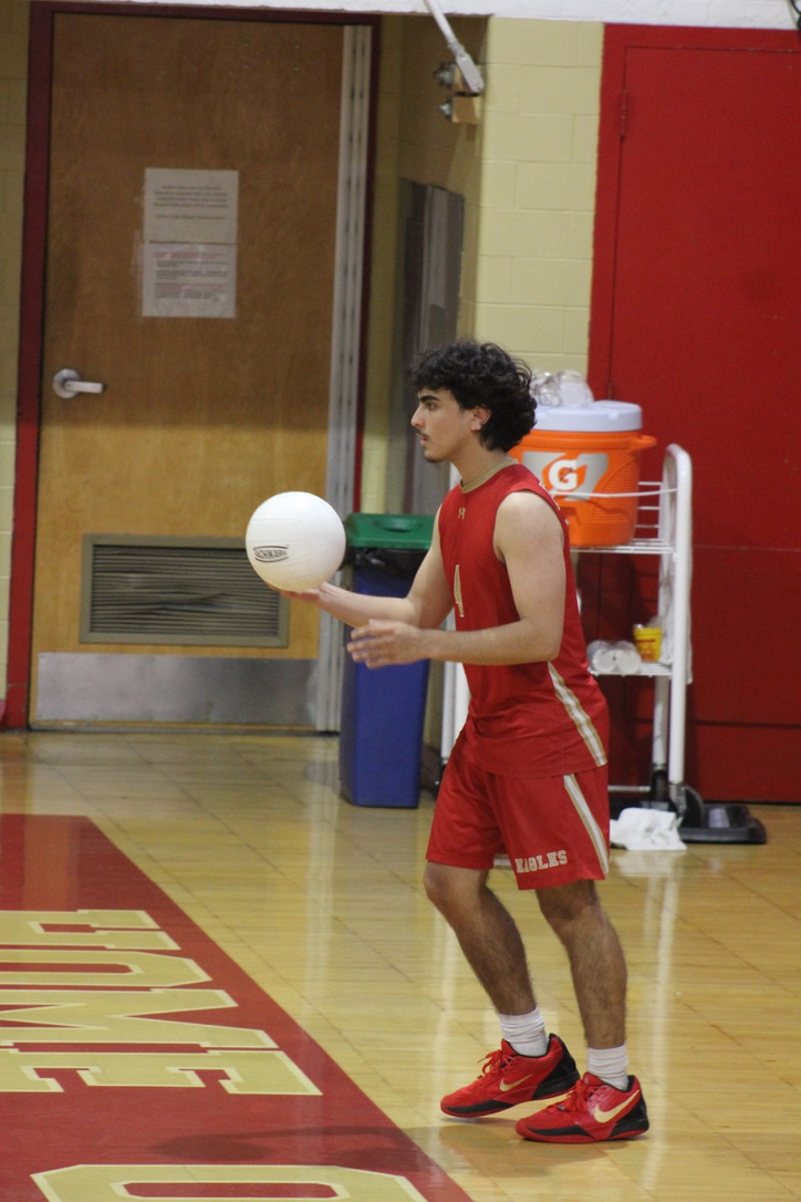 Standing at the boundary line at the back of the court, Gavin Garcia '25 gets ready to serve. 