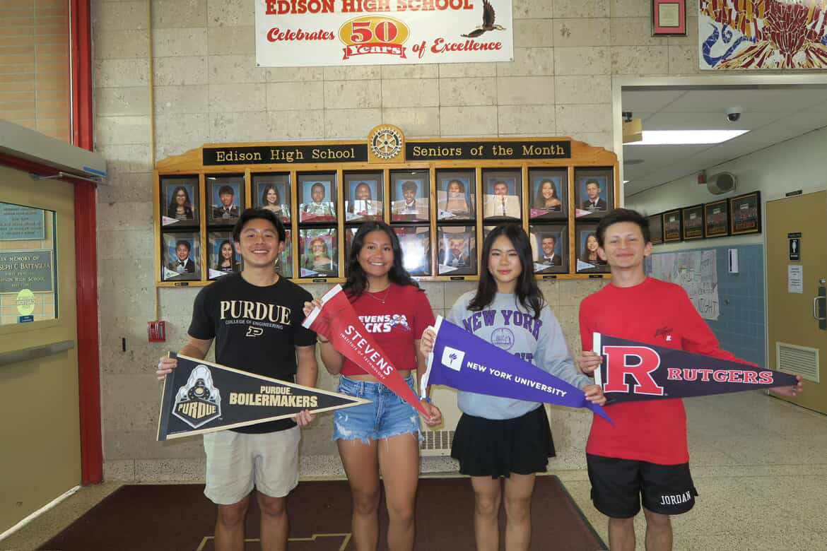 Rotary's June Senior of the Month Sylvia Wu '25 holds her New York University banner alongside her friends on decision day.