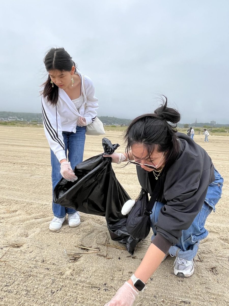 Ziling Ouyang '28 and Catherine Dharmawan '28 participate in the Rotary Beach Cleanup at Sandy Hook. They may have grabbed a shell or two to treasure in exchange for their efforts.
