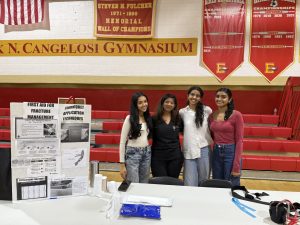 (from left to right) Aashi Tamboli '26, physician assistant Shruti Jhaveri, Pragya Bhatia '26, and Keya Patel '26 engage at the fracture management and tourniquet application stand.