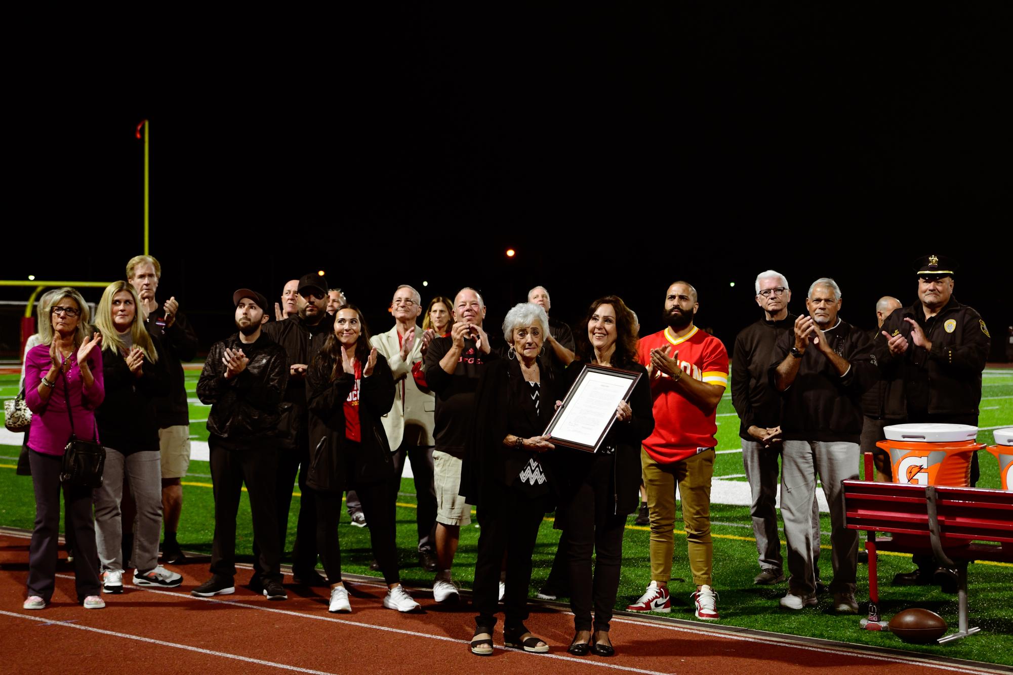 Family and friends applaud the legacy of of the late Mr. James Muldowney during his remembrance ceremony.