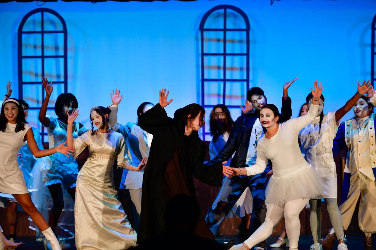 Joel Guerra '25 as Fester (center) and the Ancestors dance as they sing "Fester's Manifesto" during Act I.