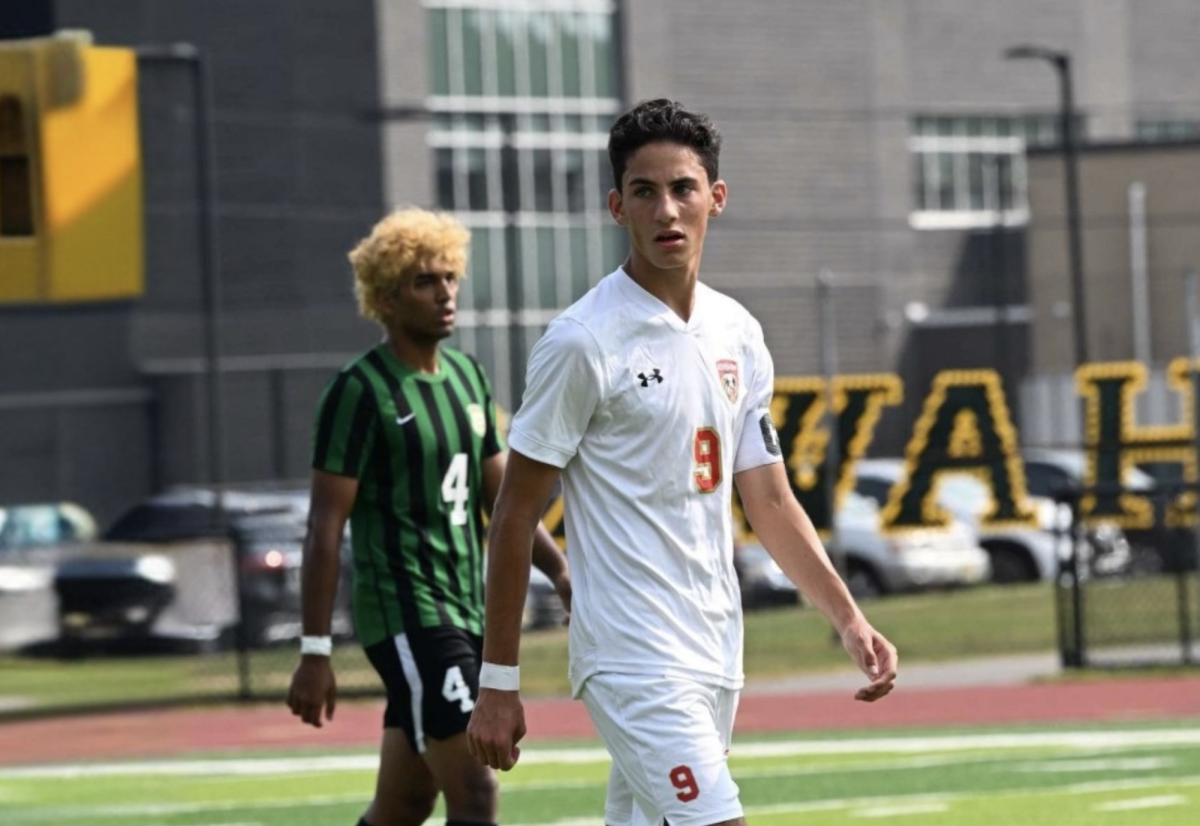 Emmanuel Kostis '26 walks onto the field, preparing to lead his team in the game.