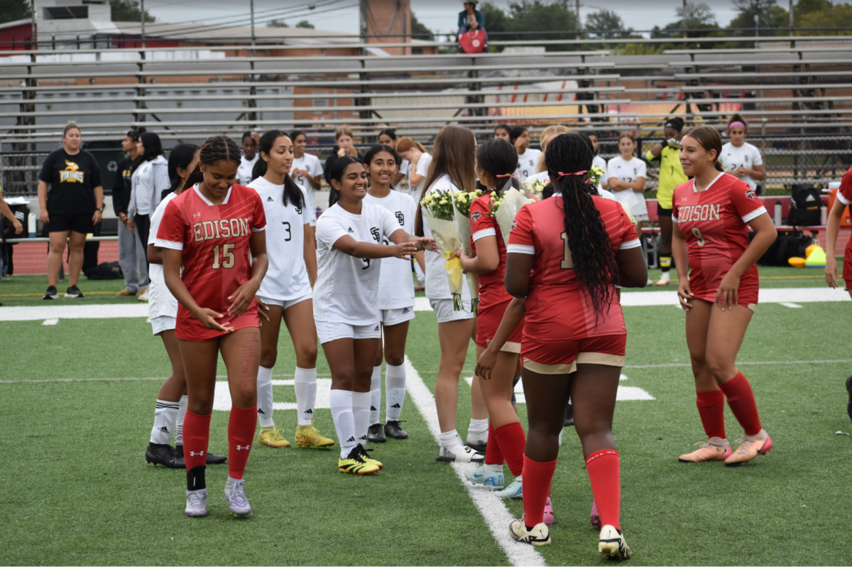 The EHS Girls Soccer team presents flowers to the South Brunswick team during Senior Night, celebrating the sportsmanship of players on both sides. 

