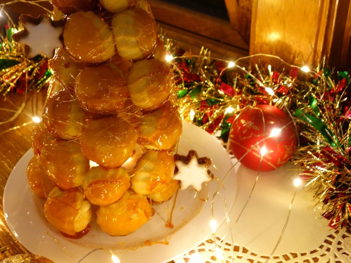 The Croquembouche glistens as the caramel refracts the light, drawing anyone's eye to the mouthwatering pastry tower.