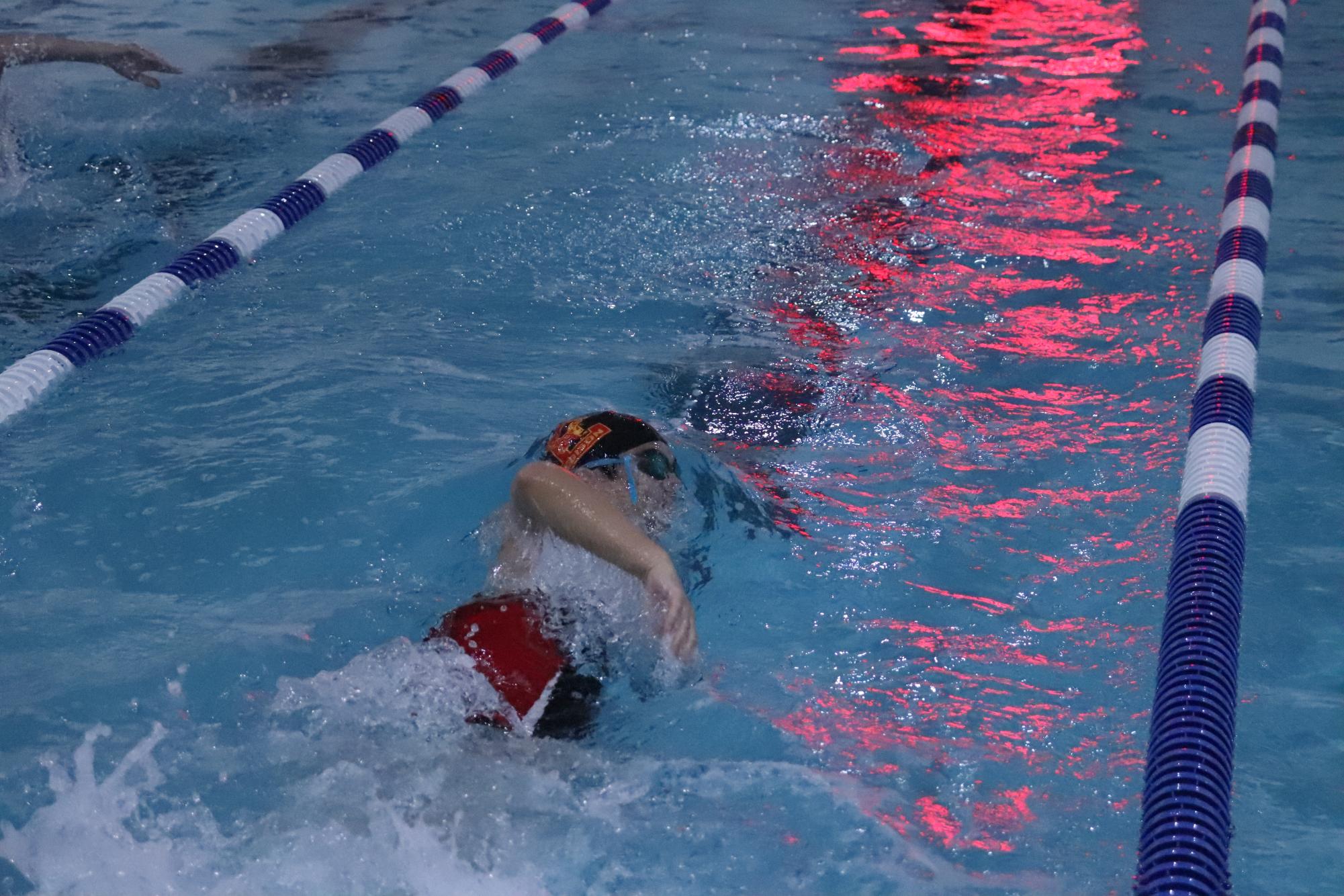 Senior, Hason Pien '26, competes in the 100-yard freestyle, powering through the water during a competitive meet.