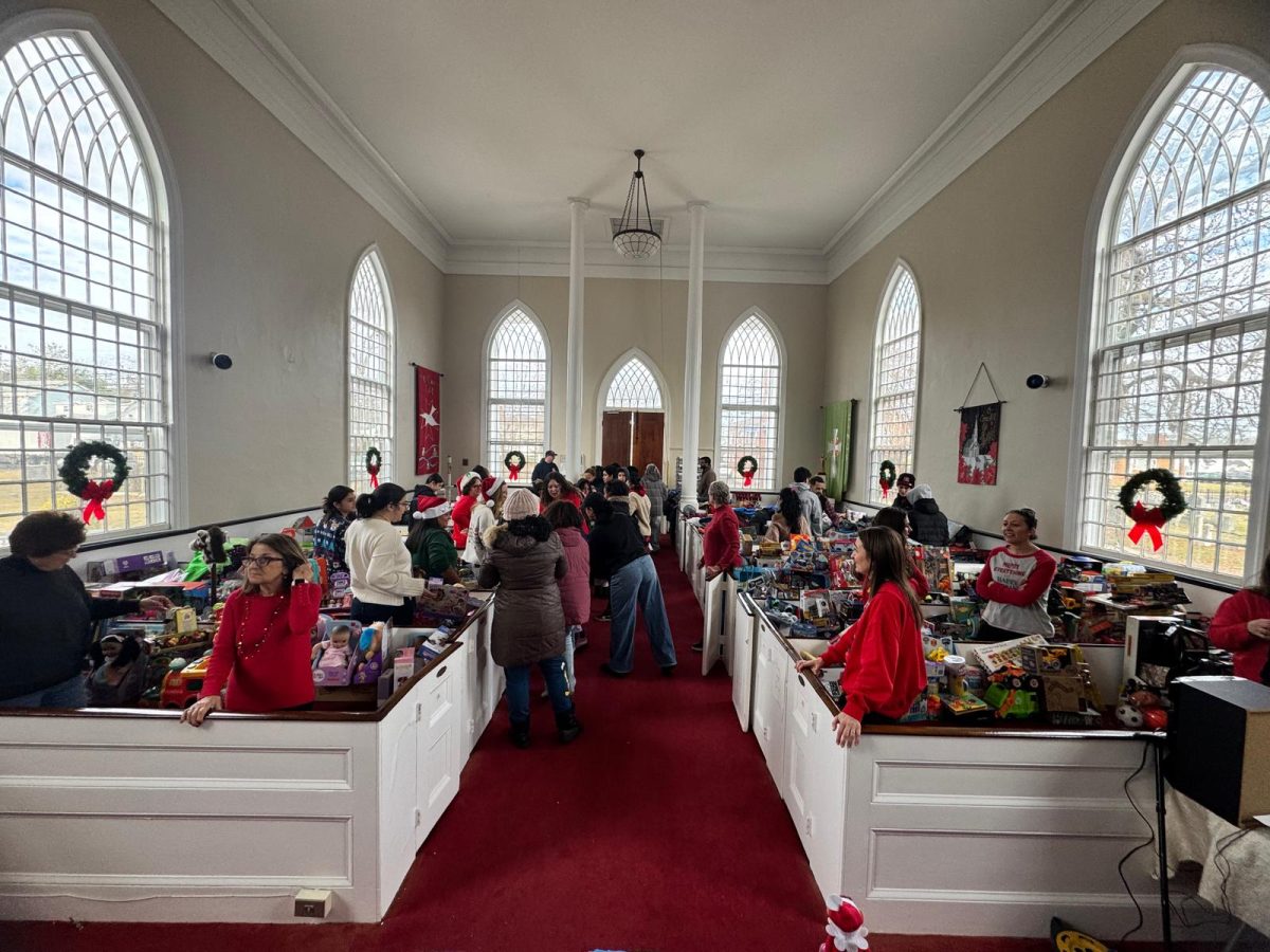 Families browse through pews overflowing with donated toys and clothing, which were organized by age group to ensure every child found a gift.