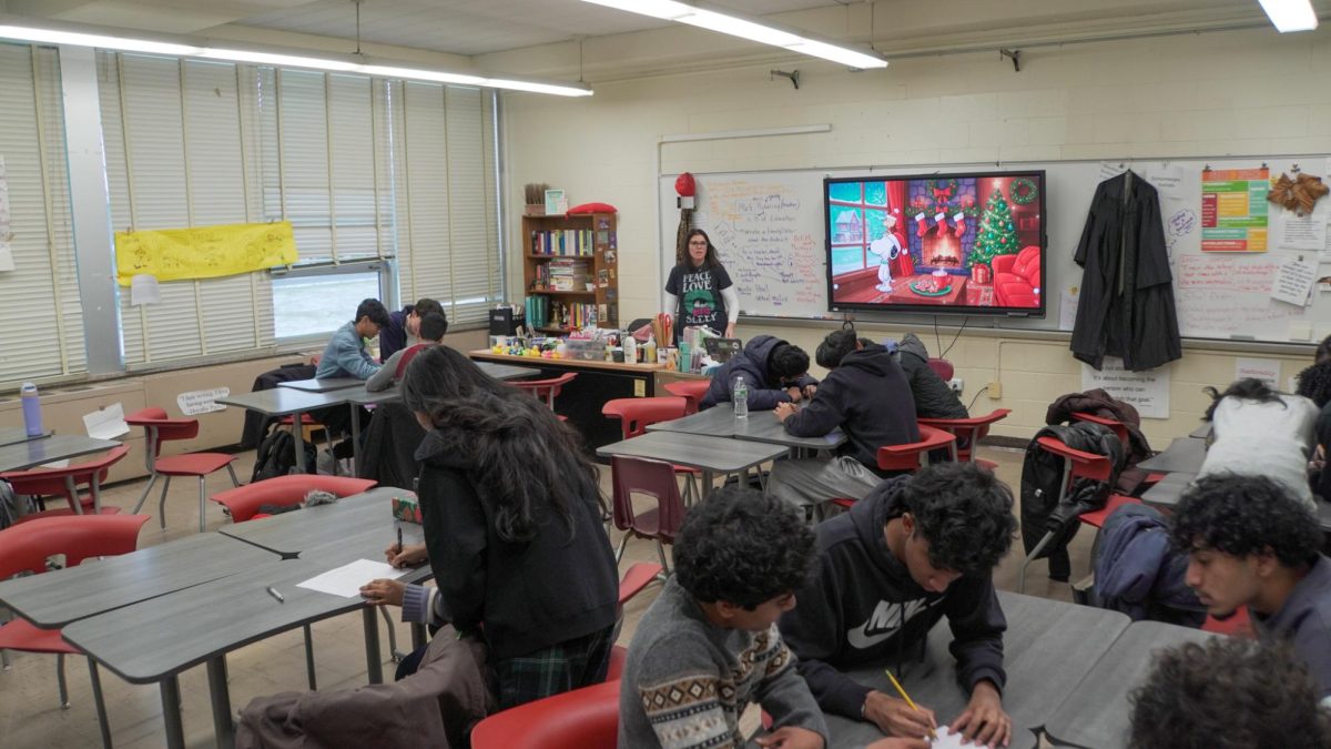 Surrounded by memorabilia and teaching elements, students of English teacher Ms. Diane Frey's AP Language and Composition class participate in a holiday "soundbite scramble" activity.