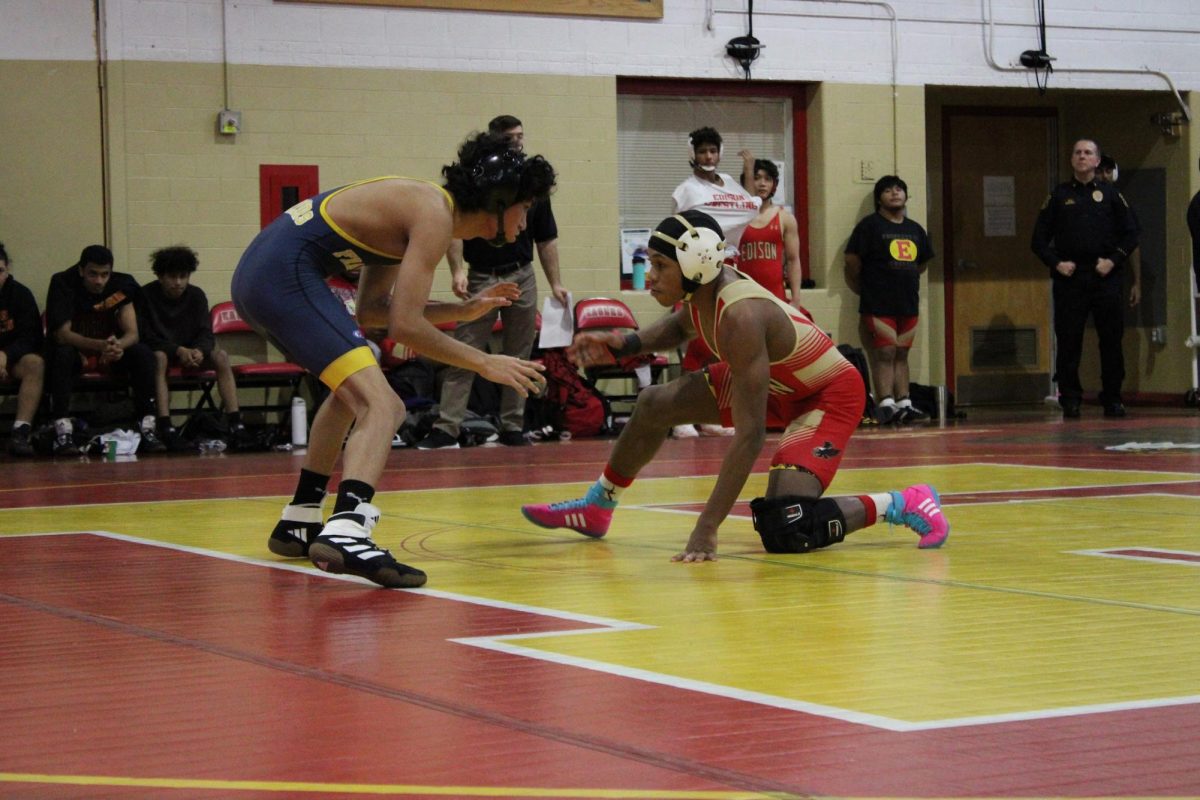Candi Northern '26 stays in a low stance, preparing to take down his opponent and pave the way for an Edison High win.