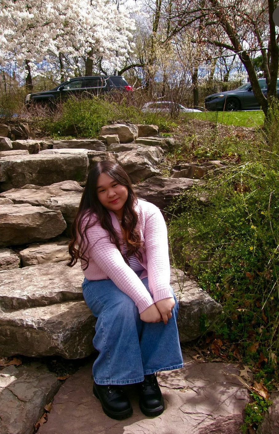 Selena Luong, November's Rotary Senior of the Month, sits at a cherry blossom tree park, one of her favorite ways to unwind and connect with nature.