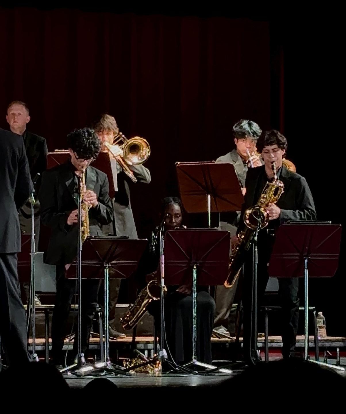 Vibunav Janaki Ashok '27 (standing, left) and Enrique Gutierrez '29 (standing, right) solo during the Jazz Ensemble's piece "Adventures."