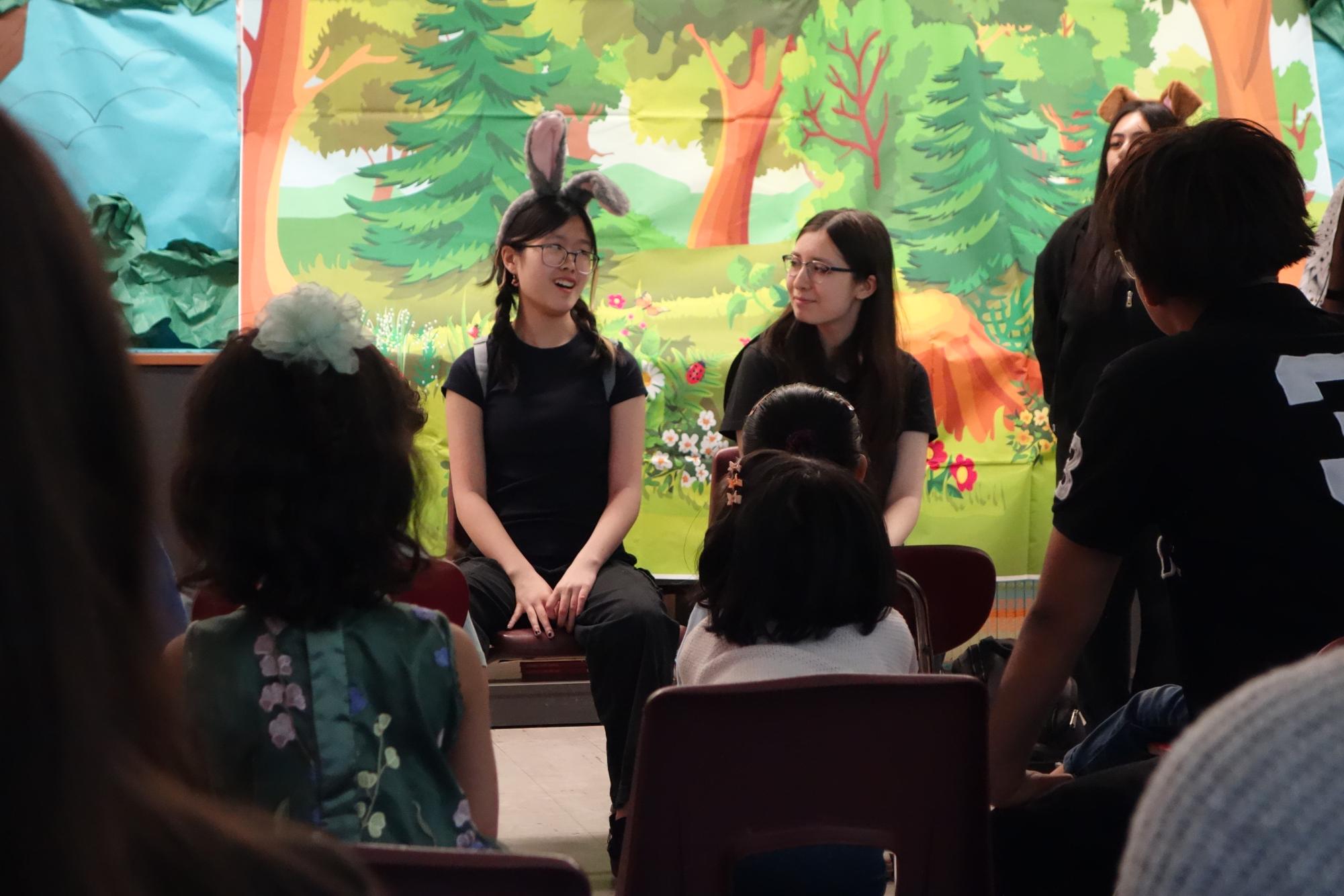 Through the last fable of the show,  Pristine Chau '29 (left) and Victoria Corodova Chumbes '26 play the Hare and Tortoise from Aesop's widely known fable, "The Tortoise and the Hare."