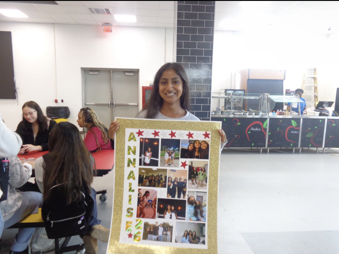 Rotary's April Senior of the Month, Annalise Dantes '26, displays a poster of her high school memories during cross country senior night. Dantes encourages students to take advantage of opportunities to build their futures.