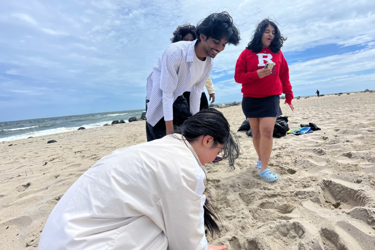 (From right) Rotary President Shriaditi Kancherla '26 and members Joshua Raj '28 and Ziling Ouyang '28 work together to clean the beach, one piece of trash at a time.